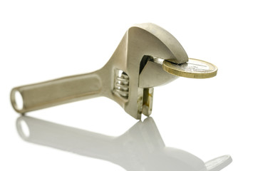 Pliers squeezing Euro coin