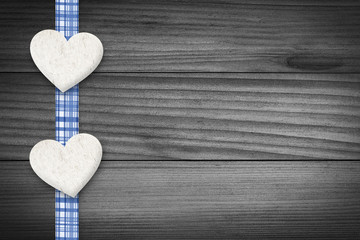 Two hearts laying on wood