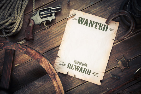 Old wanted poster on wood with vintage objects