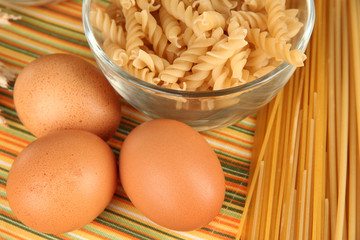 Different types of pasta on striped tablecloth