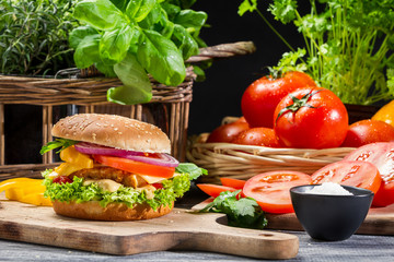 Hamburger with chicken, vegetables fresh herbs