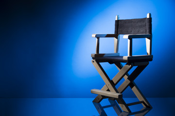 Director chair on a dramatic lit background