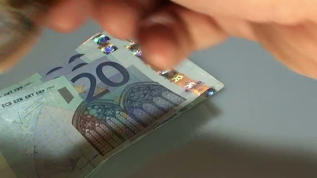 hand of a banker who has a lot of money in euro banknotes