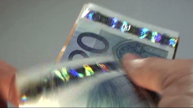 hand of a banker who has a lot of money in euro banknotes