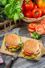 Two burgers and fresh vegetables