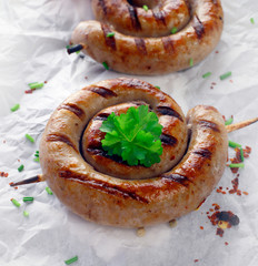 Close up of a cooked sausage in a swirl shape