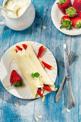 Pancakes with strawberries served with whipped cream