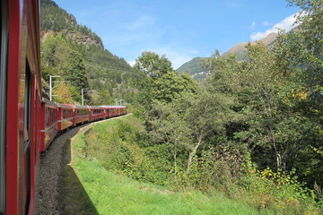 red train around the beautiful Swiss mountains 17