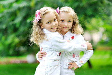 portrait of two sisters twins in the summer