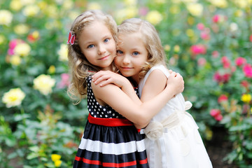 portrait of two sisters twins in the summer