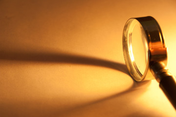 Close Up of magnifying glass with beam of light.