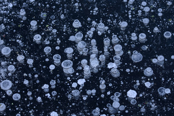 Shattered bubbles in dark blue ice, background
