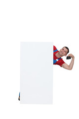 Plumber posing by poster holding purse