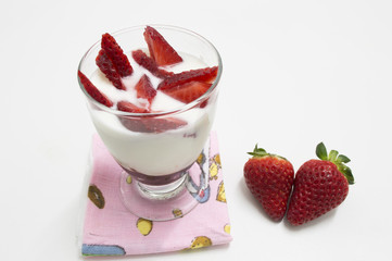 glass of yogurt with strawberries  isolated on white