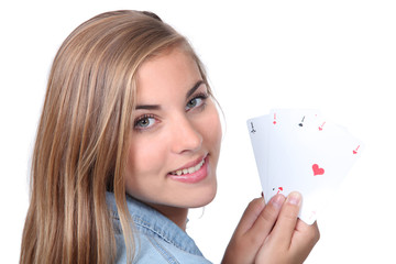 Young woman holding four aces