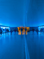 tunnel with pedestrians in motion in blue cool light