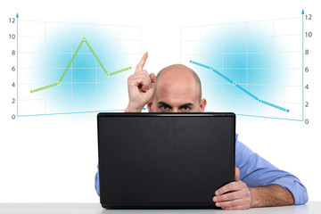 Businessman with a laptop and graphs