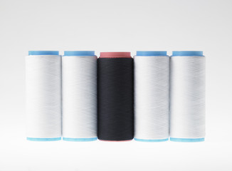 White on white, spools of thread on white background