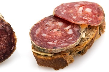 Slices of ​​sausage on bread.