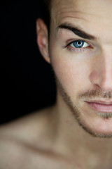 Portrait of a beautiful young man half face