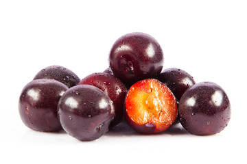 Red plum fruit isolated on white background.  Fresh ripe washed