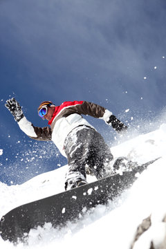 Snowboarder spraying powder