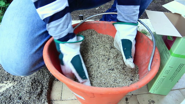 Man prepares seed and fertilizer for sowing