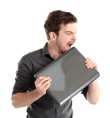 Angered office manager bites the laptop on a white background