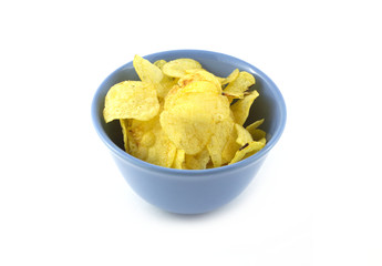 Fried potato chips in blue bowl isolated on white closeup