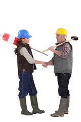 Construction workers shaking hands