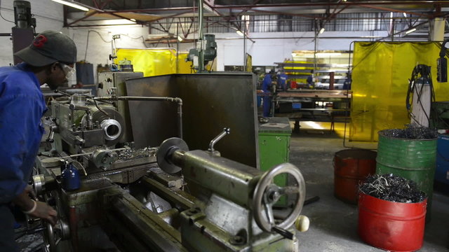 An industrial service repairmen labouring in workshop, selective