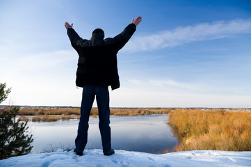 The person on the bank of the spring river