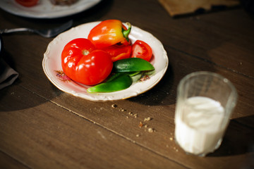Tomatoes and red bell pepper and glass of milk, breakfast