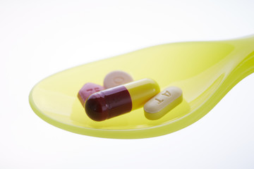 colorful pills on spoon close-up