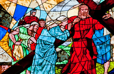 Stained glass showing Jesus carrying the cross