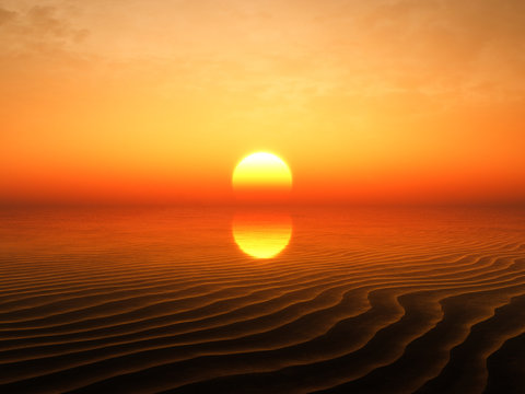 Sunset showing behind sand ripples