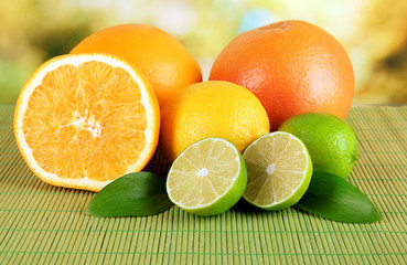 Fruits with leafs on table on bright background