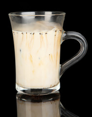 Cold coffee with ice in glass isolated on black