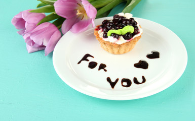 Sweet cake with blackberry and chocolate sauce