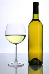 White wine glass and bottle of wine isolated on white