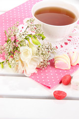 Beautiful composition with cup of tea and flowers