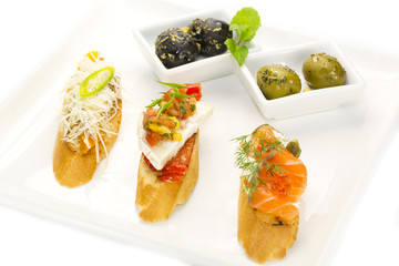 spanish sandwiches with seafood , cheese and vegetables