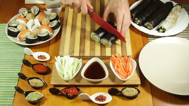 Chopping Sushi rolls in half