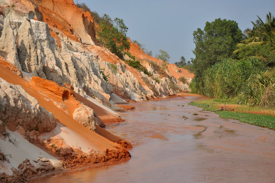 Red river between rocks and jungle, Mui Ne, Vietnam