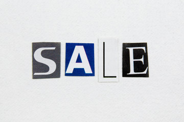 word sale cut from newspaper on white handmade paper