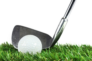 golf iron and golf ball on green grass