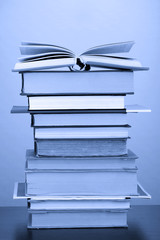 Stack of books in dark blue light