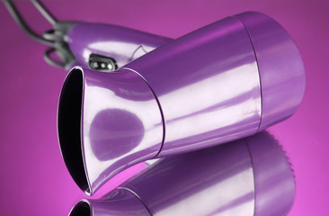 Hair dryer on purple background