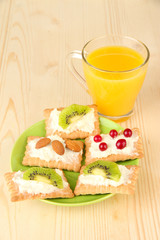 Tasty canapes with cheese, kiwi and cranberry, almond,