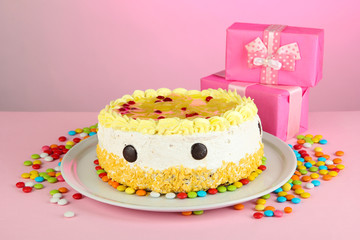 Happy birthday cake and gifts, on pink background